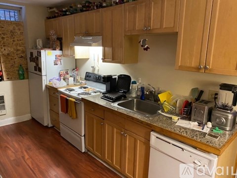 A kitchen with wooden cabinets and a granite countertop.