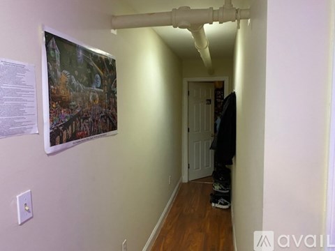 A hallway with a person standing at the end of it.