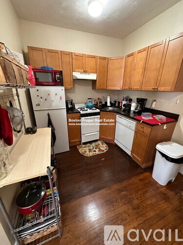 A kitchen with wooden cabinets and a white fridge.
