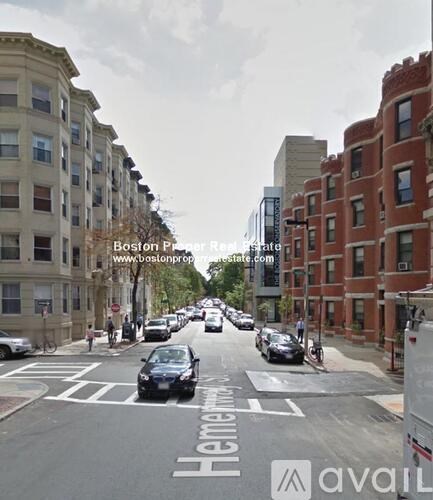 A street view of a city with cars and buildings.