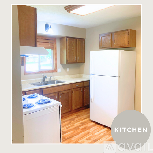A kitchen with a white fridge and a white washing machine.