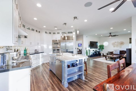 A modern kitchen with a dining table and chairs.