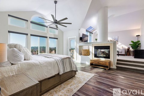 A bedroom with a large bed and a television in the corner.