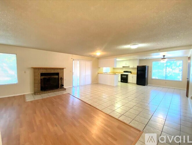 A living room with a fireplace and a flat screen TV.