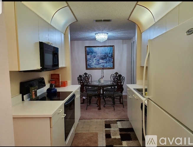 A kitchen with a table and chairs in the middle of it.