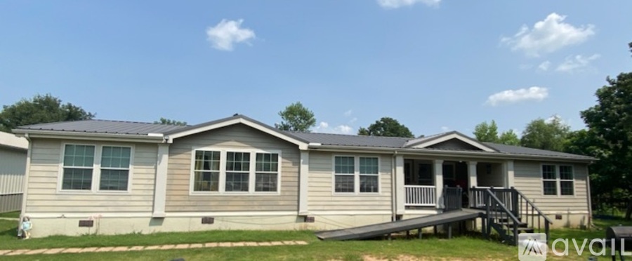 A mobile home with a porch and a covered entrance.
