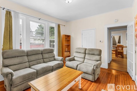 A living room with a grey sectional sofa and a wooden coffee table.