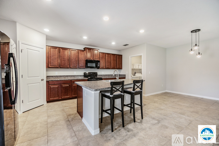 A kitchen with brown cabinets and a white island.