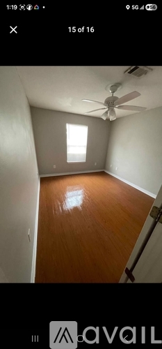 A room with a ceiling fan and a window.