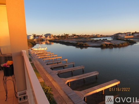 A balcony overlooks a body of water with docks.