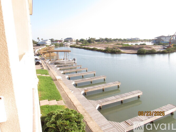 A row of wooden docks extend into a body of water.