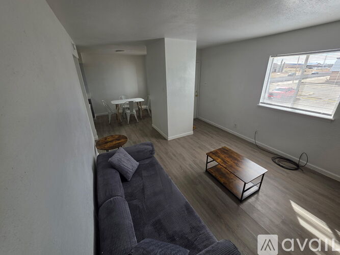 A living room with a grey couch and a wooden coffee table.