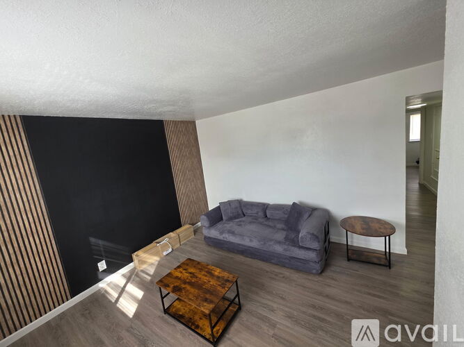 A living room with a grey sofa and a wooden coffee table.