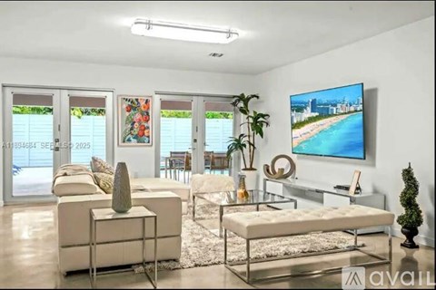 A living room with a white couch, a glass table, and a television displaying a cityscape.