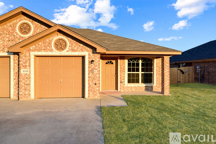 A house with a brown garage door and a brown brick wall.