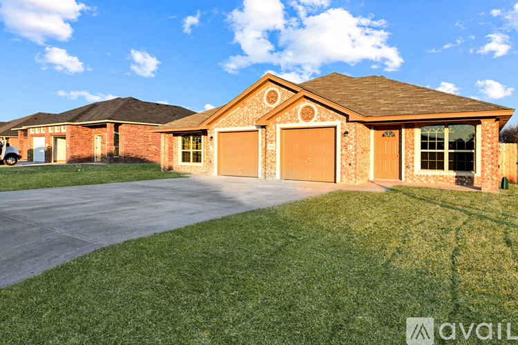 A house with a brown roof and a garage door.