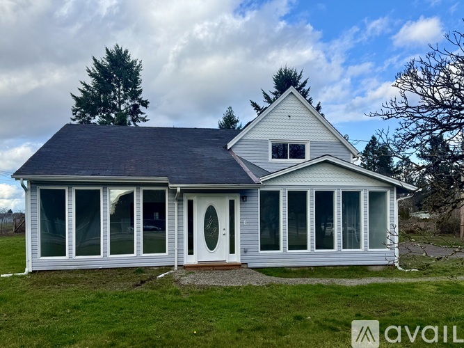 A house with a grey roof and white walls is available for purchase.