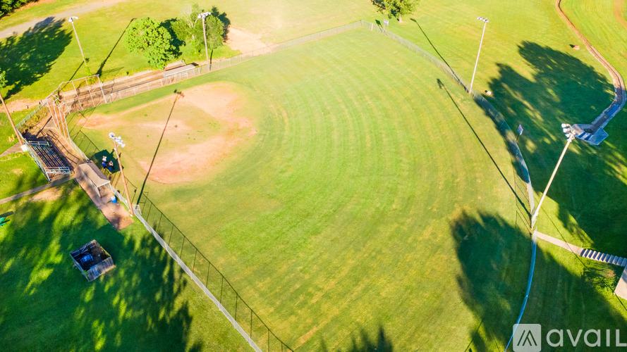A baseball field with a blue logo in the bottom right corner.
