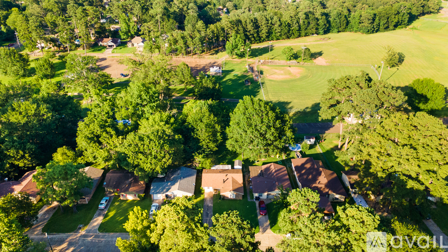 A bird's eye view of a neighborhood with houses and trees.