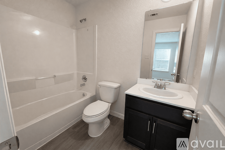 A bathroom with a toilet, sink, and bathtub.