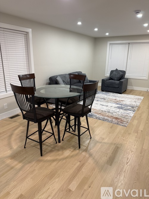 A dining room with a glass table and chairs.