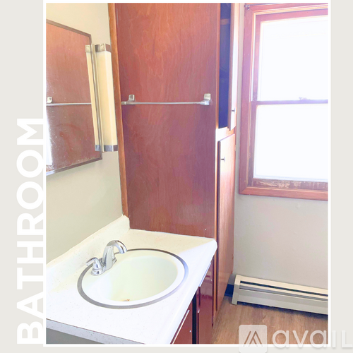 A bathroom with a sink and a towel rack.