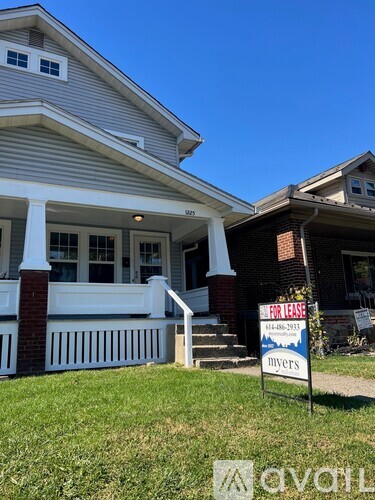 A house with a "For Lease" sign in front of it.