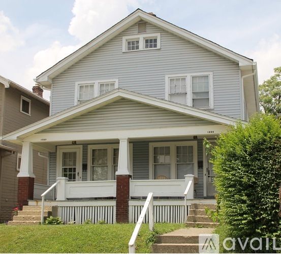 A house with a porch and a front yard.