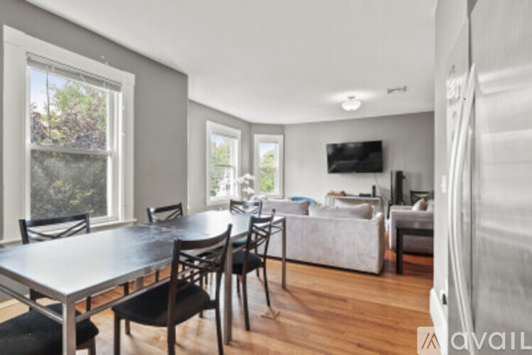 A modern dining room with a large table and chairs.