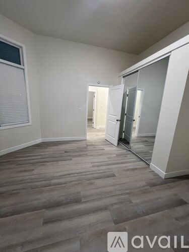 A room with wooden flooring and a glass door.