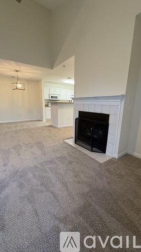 A living room with a fireplace and a carpet.