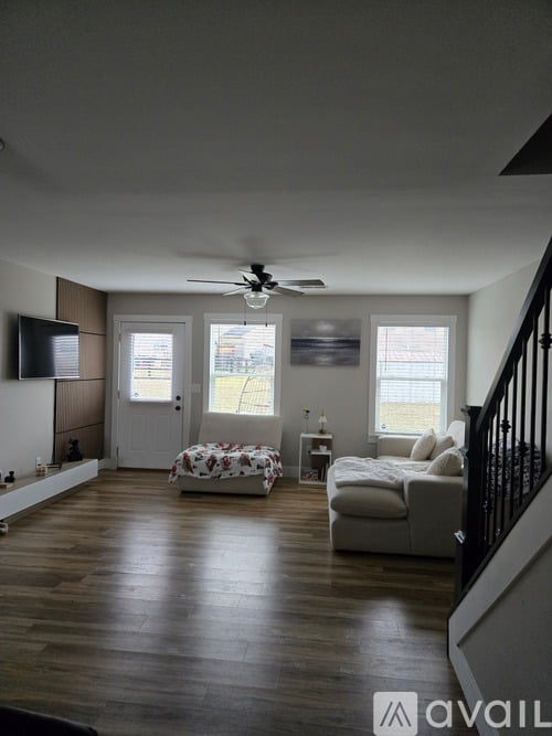 A living room with a white couch and a television.