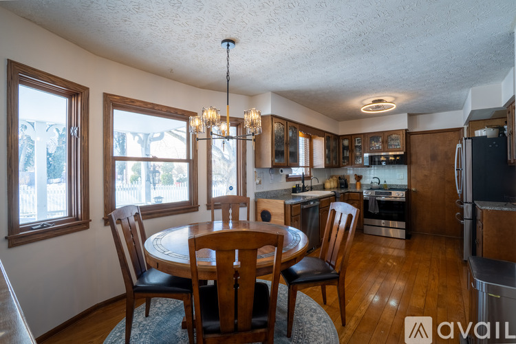 A kitchen with a table and chairs in the middle of the room.