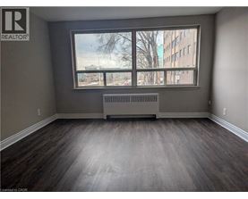 A room with a large window and a radiator on the floor.