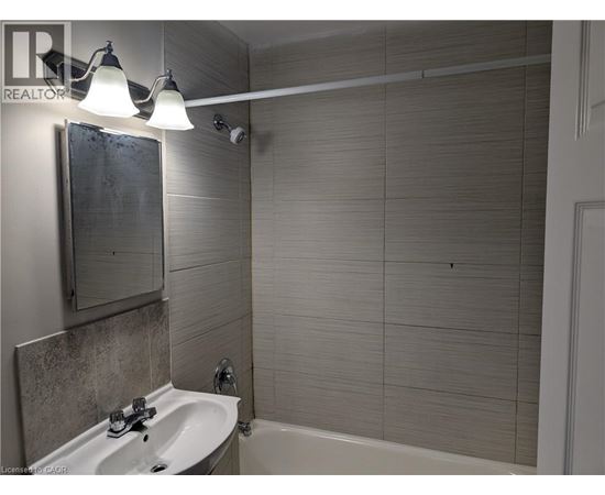 A bathroom with a white sink and a white bathtub.
