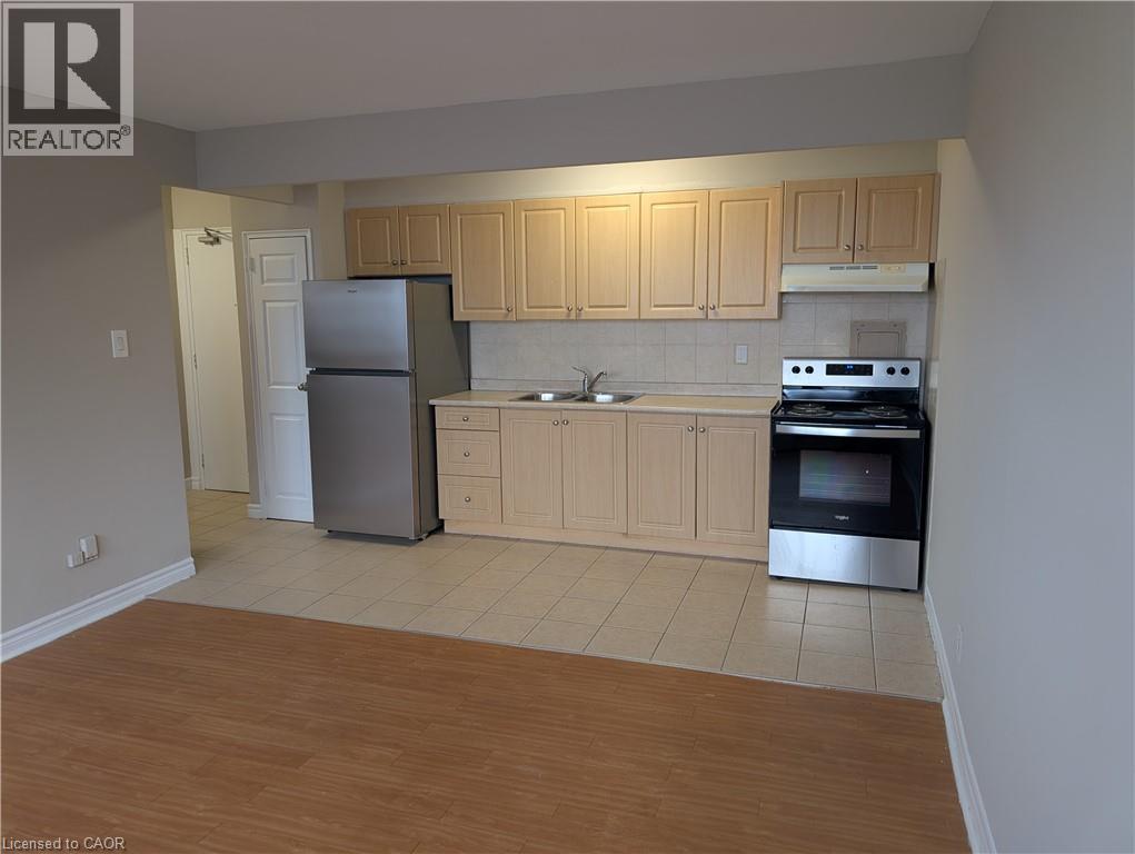 A kitchen with wooden cabinets and a refrigerator.