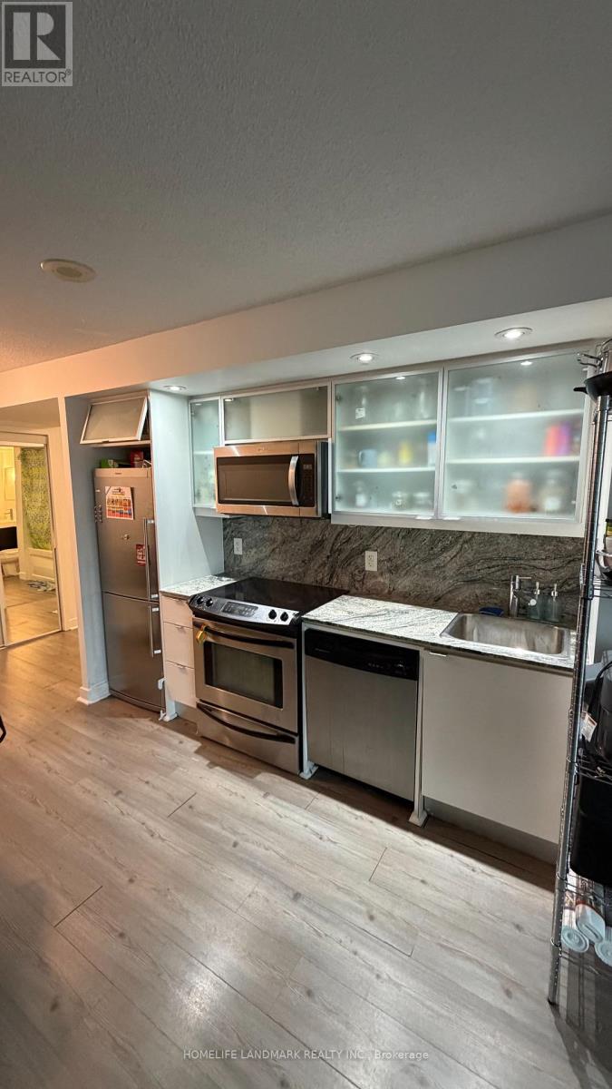 A modern kitchen with a stainless steel oven and microwave.