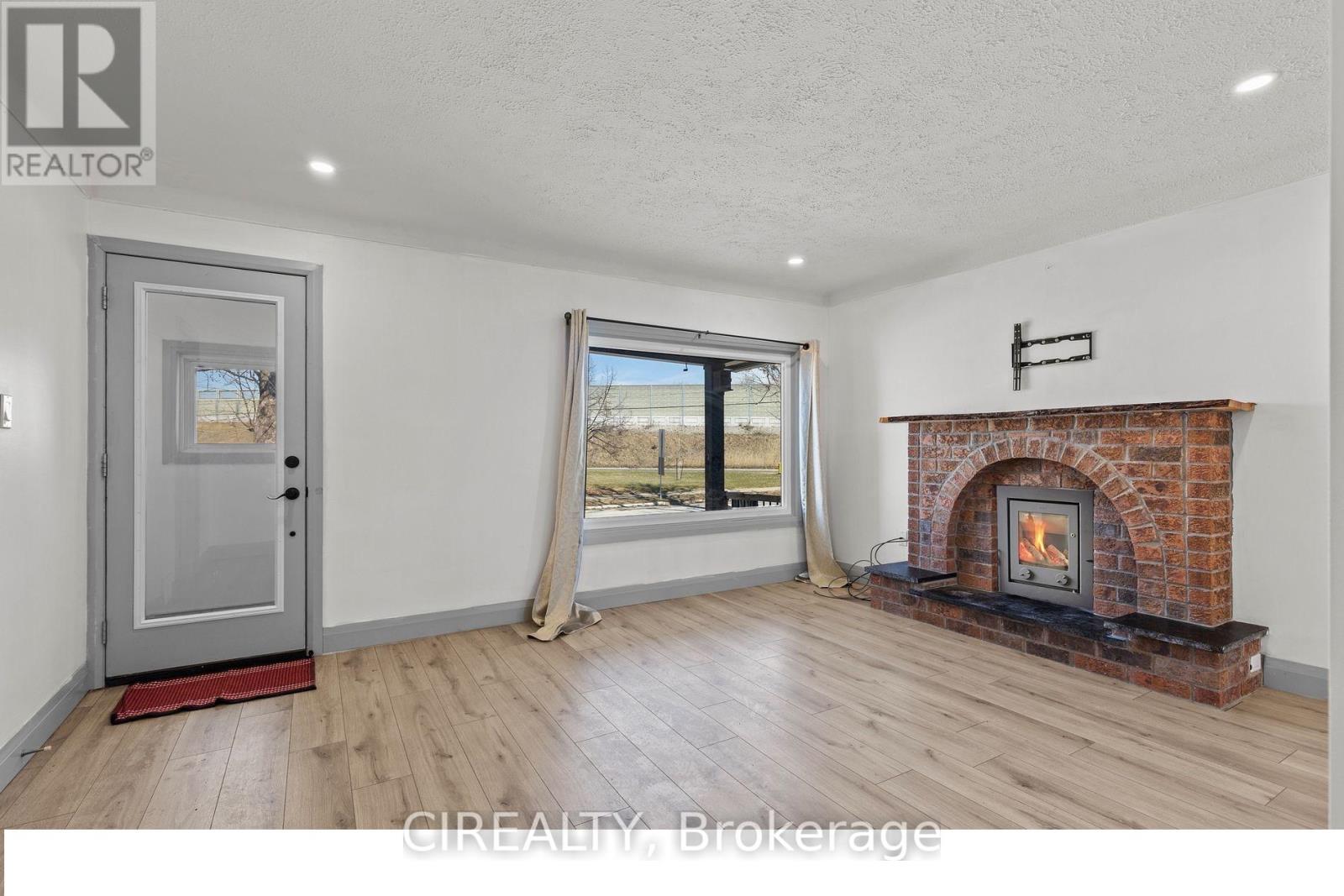 A room with a fireplace and a sliding glass door.