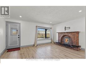 A room with a fireplace and a sliding glass door.