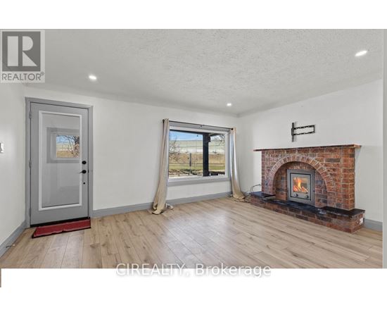 A room with a fireplace and a sliding glass door.