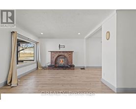 A room with a fireplace and a window with curtains.