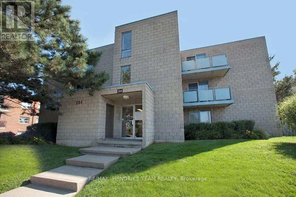 A modern two-story house with a stone facade and a glass door entrance.