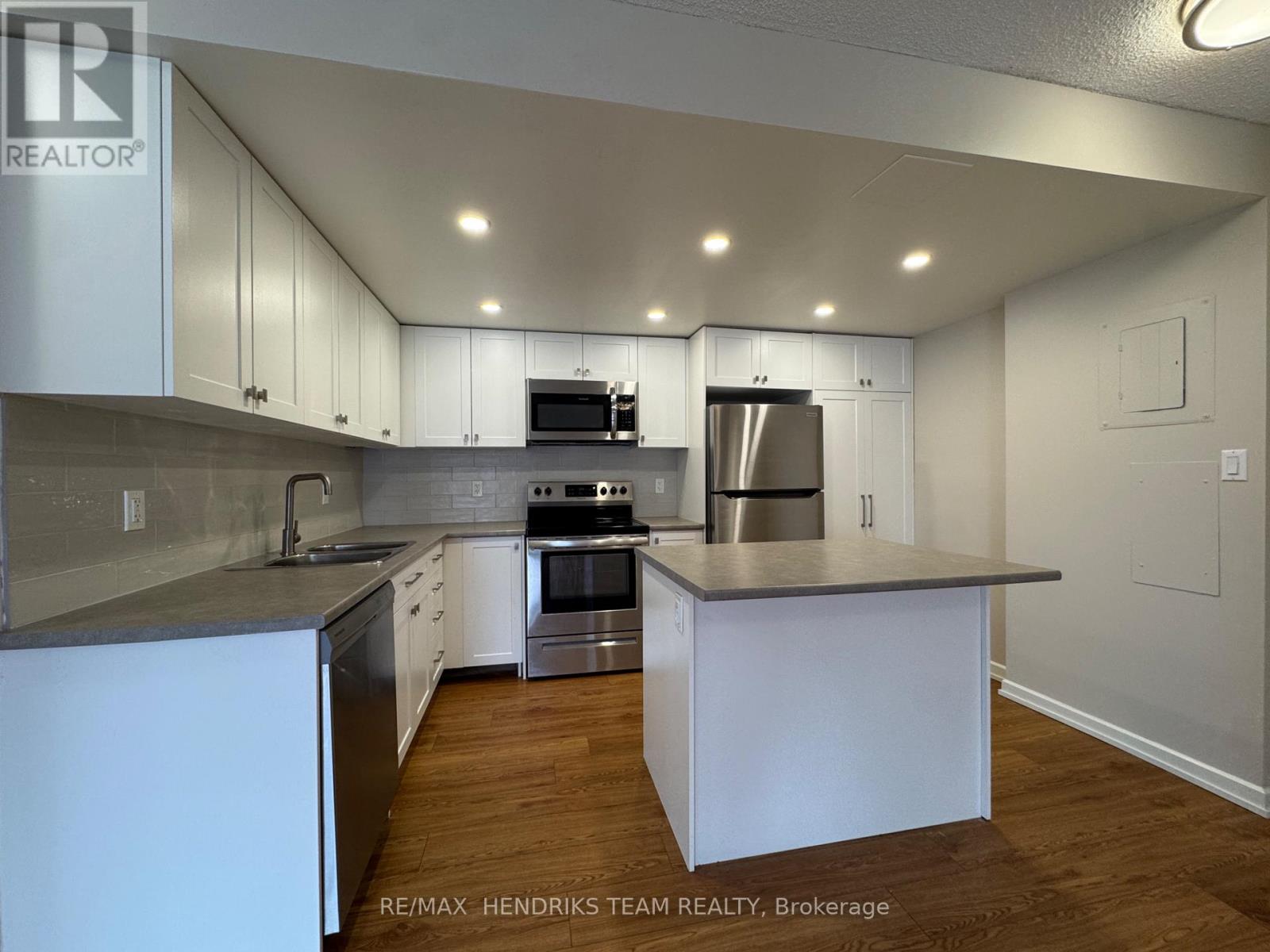 A kitchen with white cabinets and stainless steel appliances.