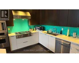 A kitchen with a stove top oven and a sink.
