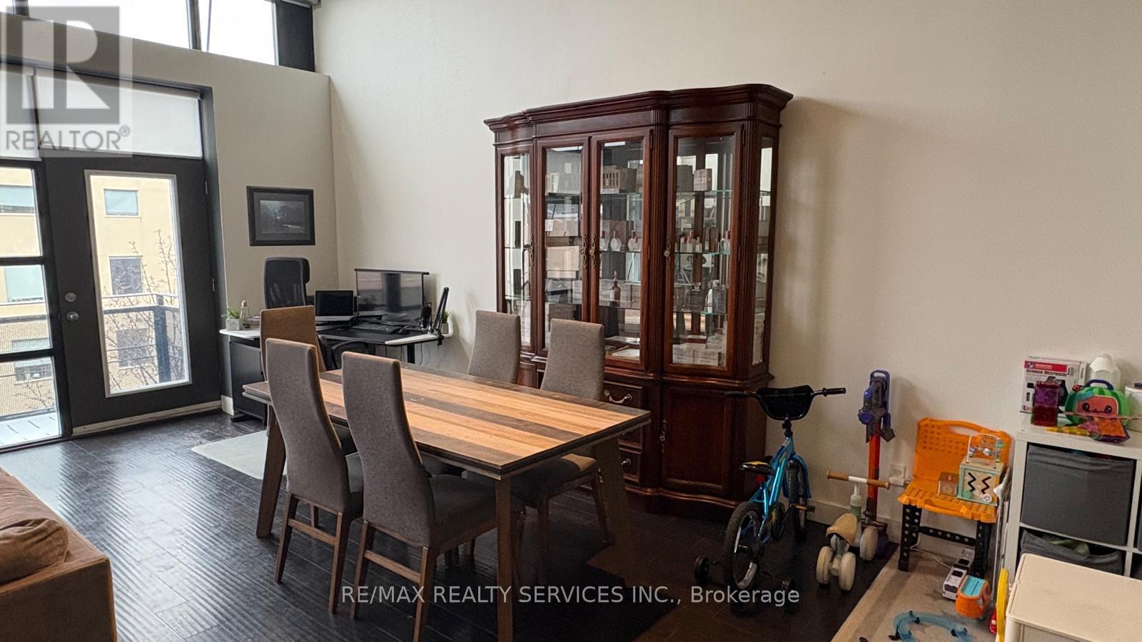 A dining room with a wooden table and chairs.
