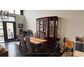 A dining room with a wooden table and chairs.