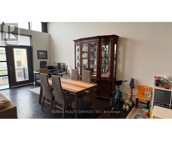 A dining room with a wooden table and chairs.