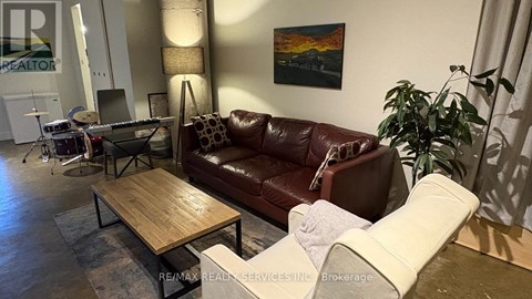 A living room with a brown leather couch and a wooden coffee table.
