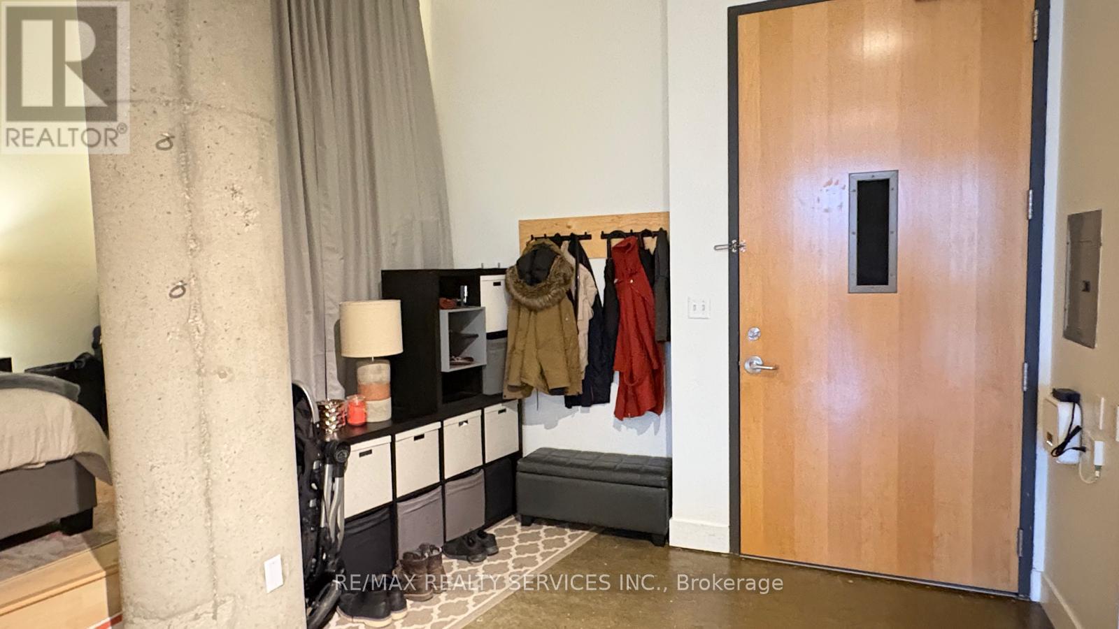 A bedroom with a bed, nightstand, and closet.