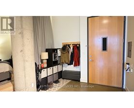 A bedroom with a bed, nightstand, and closet.
